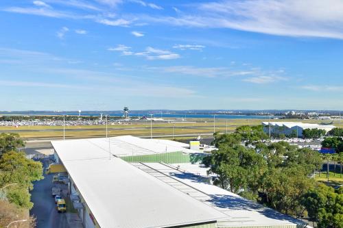 an aerial view of an airport with trees and a road at Mantra on Sydney Airport in Sydney