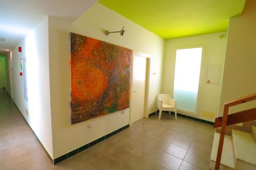a large painting on the wall of a hallway at Es Mitjorn Hotel in San Antonio