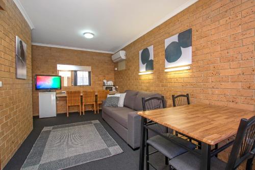 a living room with a couch and a table at River Street Motel in Ballina
