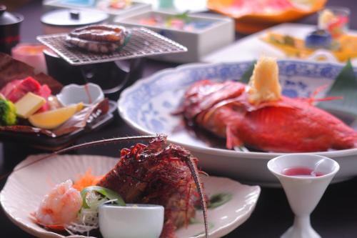 a table with plates of food on a table at Hiina in Higashiizu