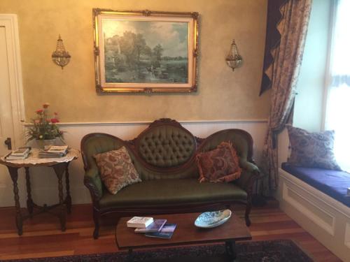 a living room with a couch and a table at The Whitmore Inn in Weaverville