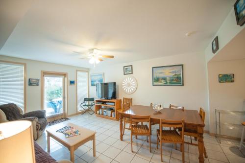 a living room with a table and a couch at South Padre Island Beach Rentals in South Padre Island