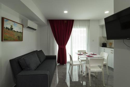 a living room with a couch and a table at Art & Wine Boutique Hotel in Larnaka