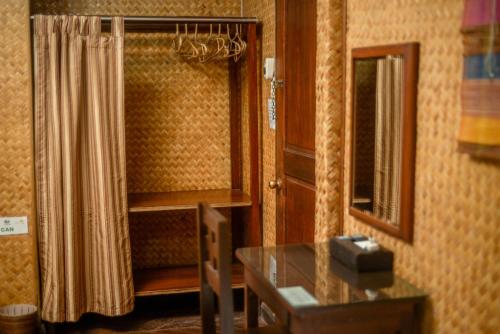 a room with a shower curtain and a mirror at Puerto Pension Inn in Puerto Princesa City