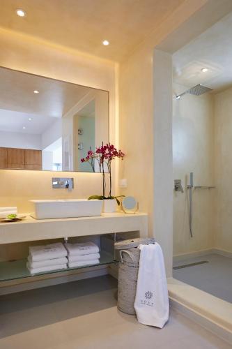 a bathroom with a sink and a mirror at Nova Luxury Suites in Pirgos