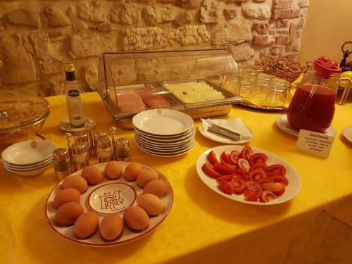 a table with plates and bowls of food on it at Hotel Fonte Cesia in Todi