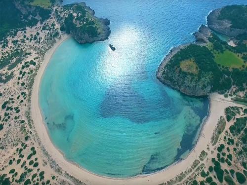an aerial view of a beach with blue water at Belvedere Hotel in Kalamata