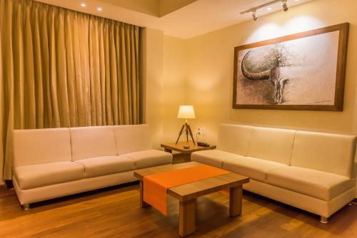 a living room with a couch and a table at Sangai Continental (The Boutique Hotel) in Imphal