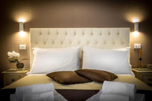 a bedroom with a large bed with two pillows at Sognando Firenze in Florence