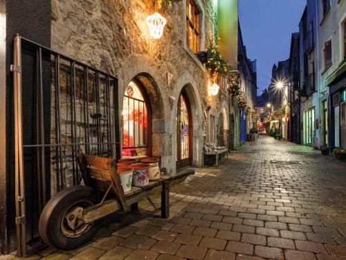 an empty street at night with a cart on the street at HYDE Hotel in Galway