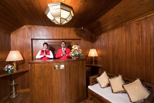 two people are standing in a wooden room at La Grande Villa in Nuwara Eliya