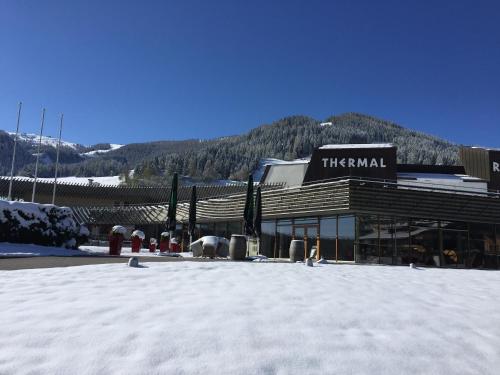 a large building with snow in front of it at Pension Gertraud in Bad Kleinkirchheim