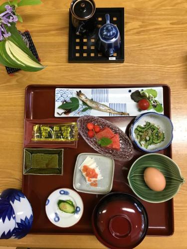 a tray of food on a table with food at Ryokan Seifuso in Ōmuta
