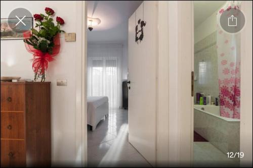 a room with a bathroom with a vase of flowers at Appartamento Serapo in Gaeta