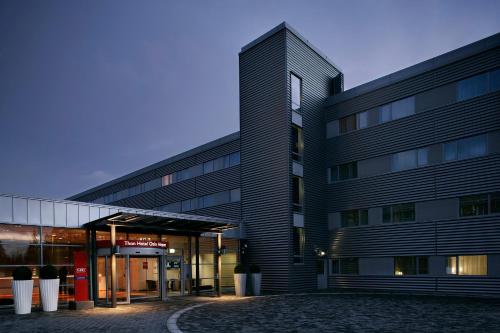 a large building with a building at Thon Hotel Oslo Airport in Gardermoen