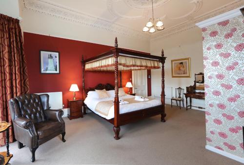 a bedroom with a large bed and a large window at Ard Na Said in Edinburgh