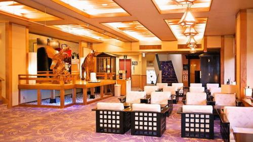 a lobby of a hotel with a waiting room with chairs at Hotel Manyotei in Nikko
