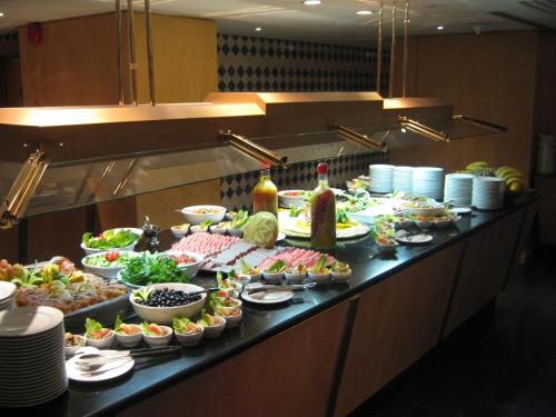 a buffet line with many different types of food at New Madinah Hotel in Al Madinah