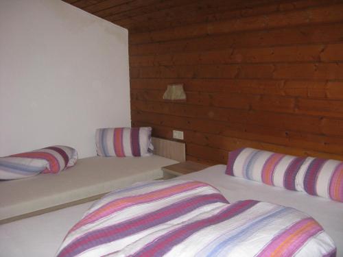 a bedroom with two beds with striped pillows at Ferienwohnung Wohlfarter in Jerzens