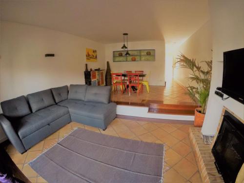 a living room with a couch and a dining room at Beach House in Madalena