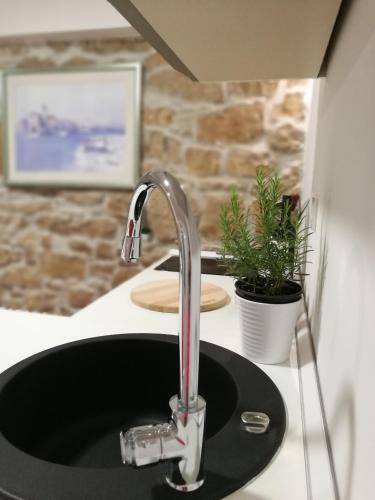 a sink with a faucet in a kitchen at Littel studio Franceska in Jezera