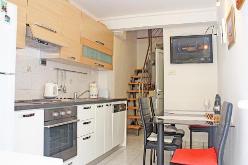 a kitchen with a table and a dining room at Apartment Tomislav in Zaostrog