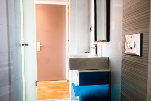 a bathroom with a sink and a mirror at Victoria Hotel in Nafplio