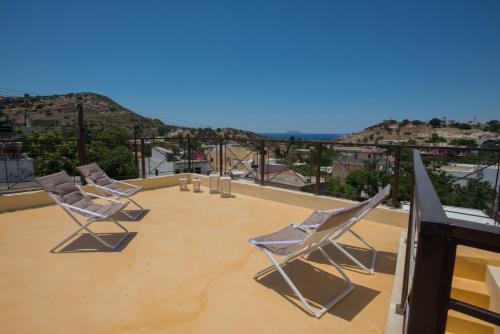 a group of chairs sitting on top of a roof at Kritikies in Pitsidia