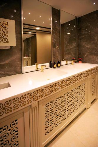 a bathroom with two sinks and a large mirror at The Escape Hotel in Agva