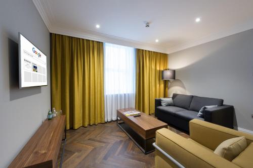 a living room with a couch and a table at Claremont Hotel in Douglas