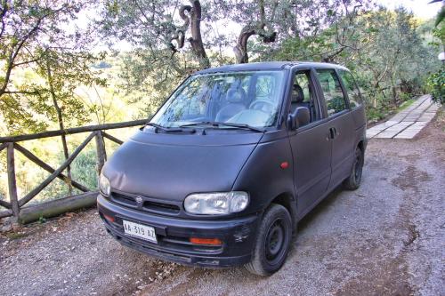 a small blue van parked next to a fence at Casarufolo Paradise in Sorrento