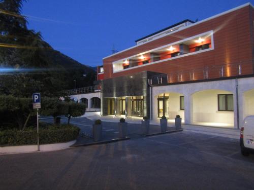 a building with a parking lot in front of it at Bhotel in Lagonegro
