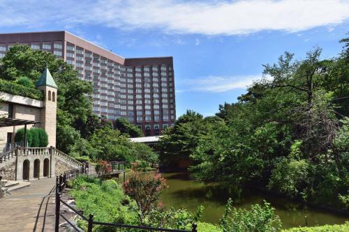 a view of a building and a river at Hotel Chinzanso Tokyo in Tokyo