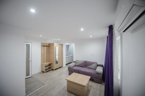 a living room with a couch and a coffee table at Casa Dinii in Constanţa