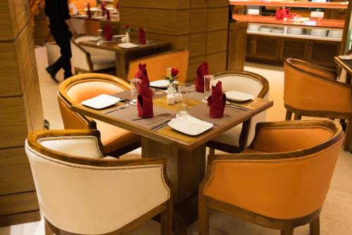 a table in a restaurant with red napkins at Sangai Continental (The Boutique Hotel) in Imphal