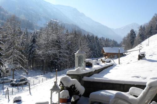 a village covered in snow with mountains in the background at Spacious Swiss Alpine Chalet for Nature Lovers in Val dʼIlliez