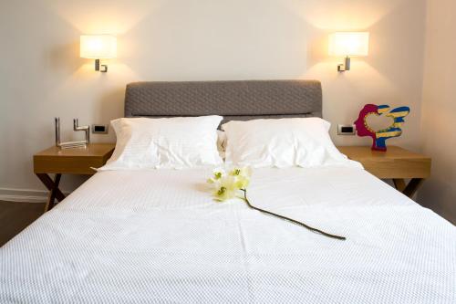 a bedroom with a white bed with flowers on it at Gambello Luxury Rooms in Nafplio