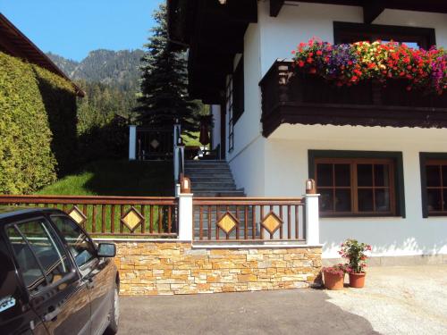 a house with a balcony with flowers on it at Fürstenhof in Alpbach