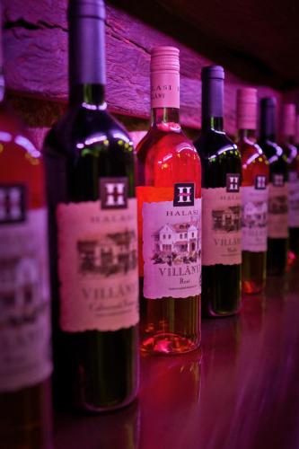 a row of bottles of wine sitting on a table at Halasi Pince Panzió in Villány