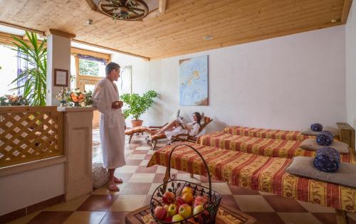 a man is standing in a living room at Ferienhof Kampfl in Fügen