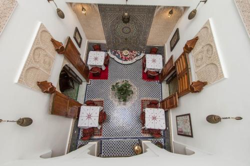 an overhead view of a room with tables and chairs at Dar Fes Medina Ziat in Fez