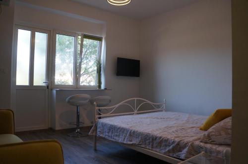 Säng eller sängar i ett rum på Apartments Valentino