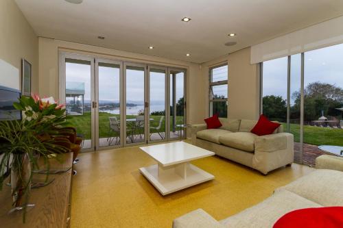 a living room with a couch and a table at No1 Sangaree in Plettenberg Bay