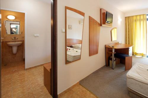 a room with a bathroom with a sink and a mirror at Paloma - in the center of the city in Sunny Beach