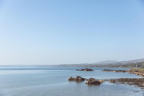 a river with some rocks in the water at Redcastle Hotel in Moville