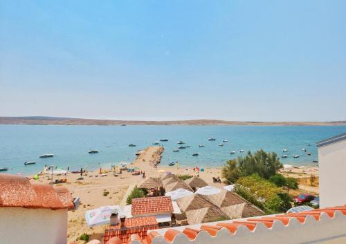 a view of a beach with boats in the water at Apartments Barbati in Novalja