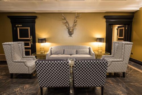 a living room with a couch and two chairs at Gleddoch Golf & Spa Resort in Langbank