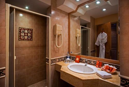 a bathroom with a sink and a mirror at Stella Sea Club Hotel in Ain Sokhna