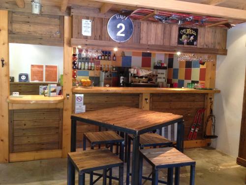 a restaurant with a table and two stools at Camping Mon Repos in Montmaur