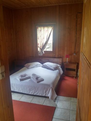 a bedroom with a bed with two towels on it at Livadaki Village in Megáli Kápsi